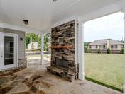 Cozy Outdoor Fireplace with Large Patio and Firepit at Provence by Waterford Homes at Regency Point